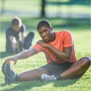 Athlete in a red sports outfit poised at the starting line of a blue track, ready to sprint with energy and focus. Miraculous Health offers the finest vitamins and supplements to fuel your health and wellness journey. Visit MiraculousHealth.org to learn more!